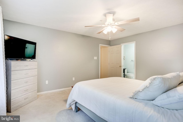 carpeted bedroom featuring ensuite bath and ceiling fan