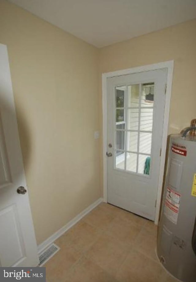 doorway to outside featuring electric water heater