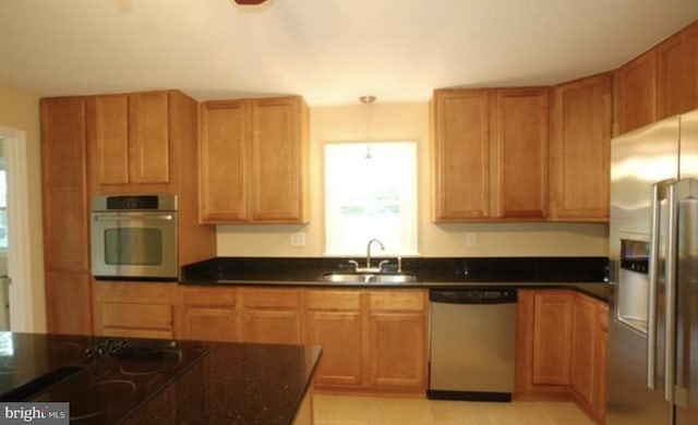 kitchen with sink, stainless steel appliances, and hanging light fixtures