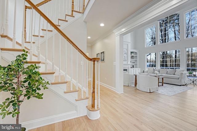 entrance foyer featuring crown molding and light wood-type flooring