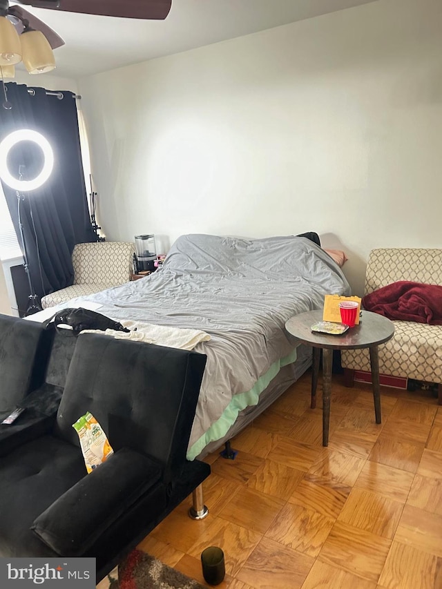 bedroom with light parquet flooring and ceiling fan