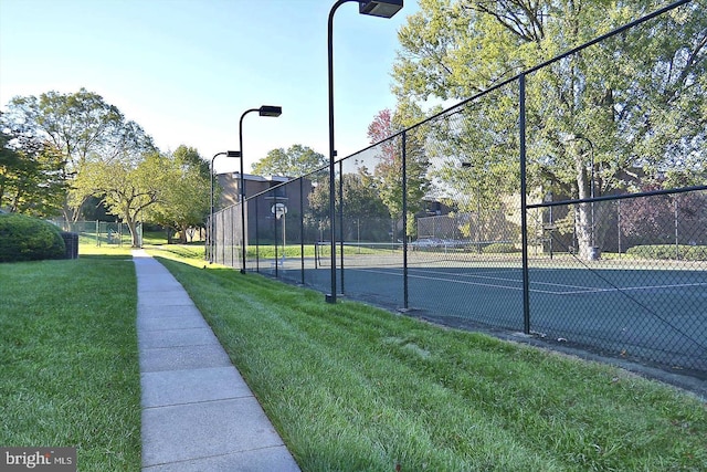 view of sport court featuring a yard