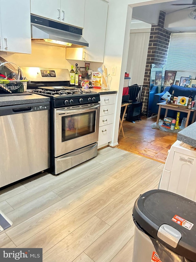 kitchen featuring white cabinets, stainless steel appliances, ceiling fan, and light hardwood / wood-style floors