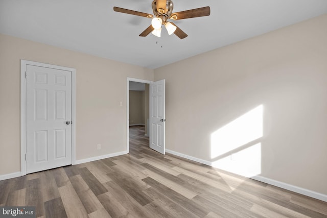 unfurnished bedroom with ceiling fan and light hardwood / wood-style flooring