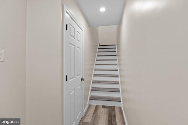 stairway with hardwood / wood-style flooring