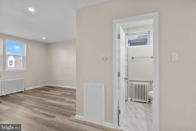 entrance foyer with light hardwood / wood-style flooring and radiator heating unit