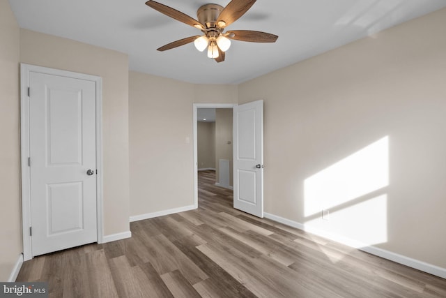 unfurnished bedroom featuring ceiling fan and light hardwood / wood-style flooring