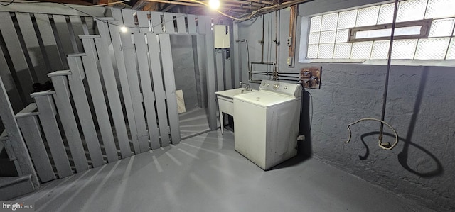 basement with sink and washer / dryer