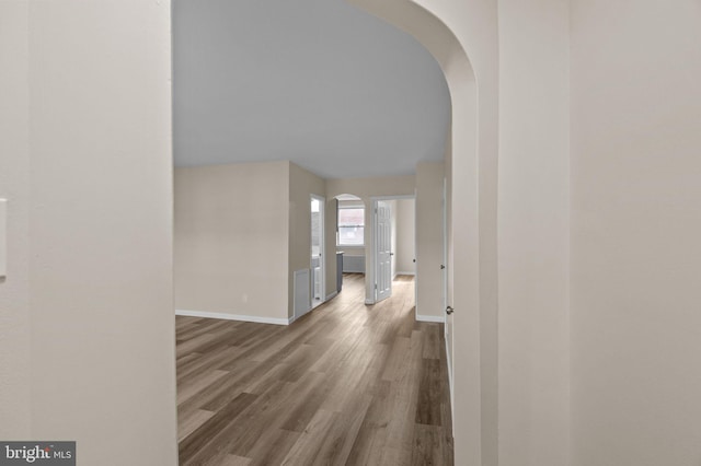 hallway with hardwood / wood-style floors