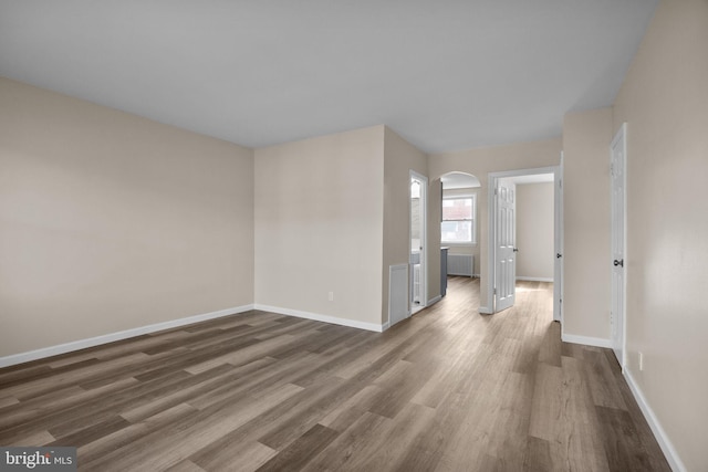 spare room with dark hardwood / wood-style flooring