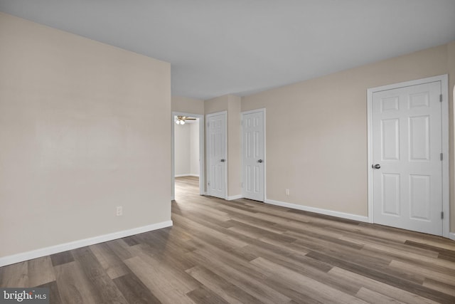 unfurnished room with ceiling fan and hardwood / wood-style flooring