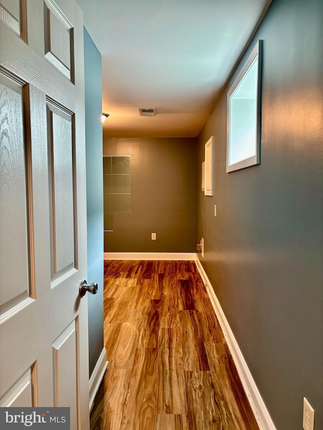 hallway with hardwood / wood-style floors