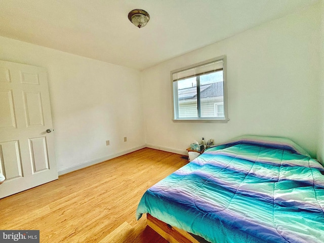 bedroom with hardwood / wood-style flooring