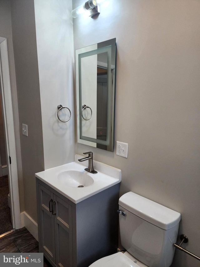 bathroom featuring vanity and toilet