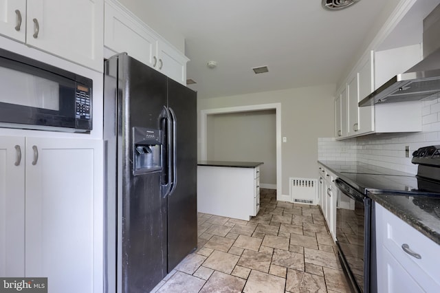 kitchen featuring wall chimney exhaust hood, dark stone counters, decorative backsplash, white cabinets, and black appliances