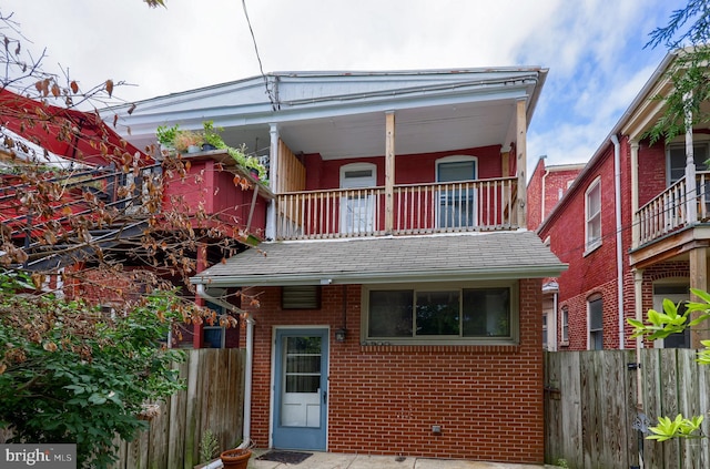 rear view of property with a balcony