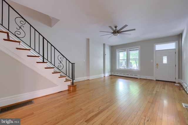 foyer featuring ceiling fan, light wood-type flooring, and a baseboard radiator