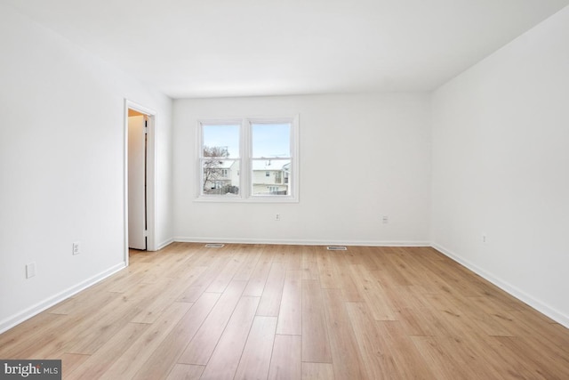 empty room with light hardwood / wood-style floors