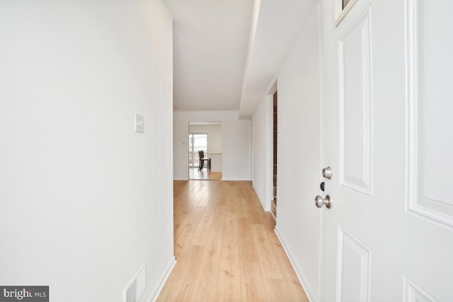 corridor with light wood-type flooring