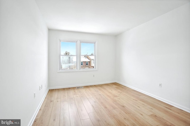 empty room with light hardwood / wood-style floors