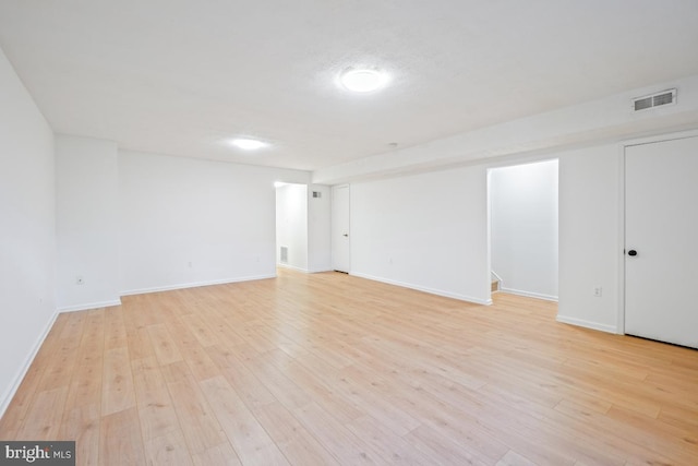 basement with light hardwood / wood-style flooring