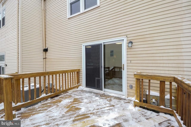 snow covered deck featuring cooling unit