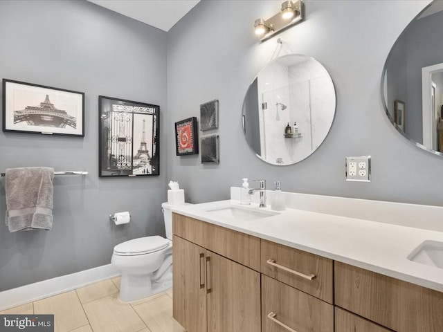 bathroom featuring vanity, toilet, and tile patterned flooring