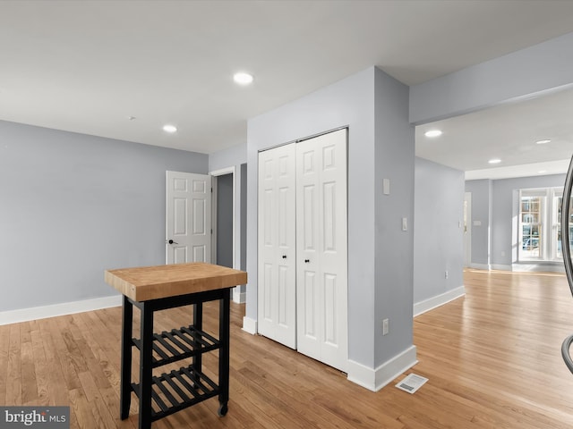 corridor with light hardwood / wood-style floors