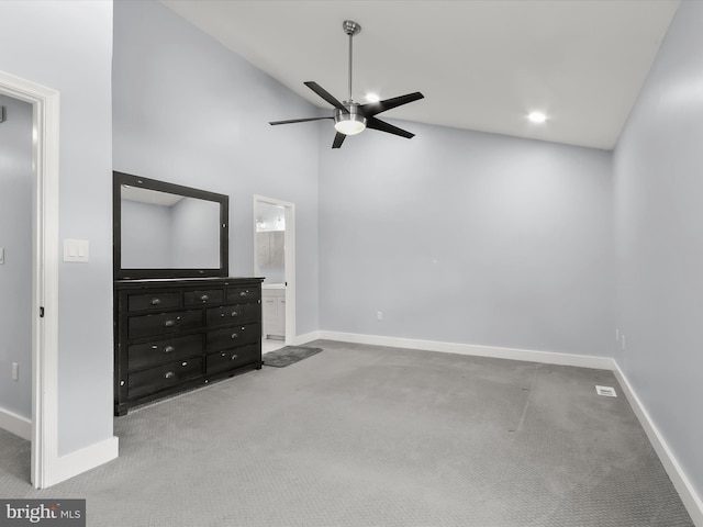 unfurnished bedroom featuring ensuite bath, high vaulted ceiling, carpet floors, and ceiling fan