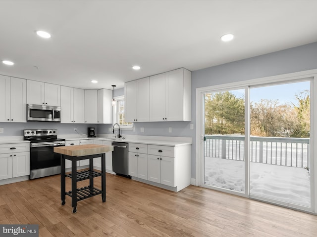 kitchen with appliances with stainless steel finishes and white cabinetry