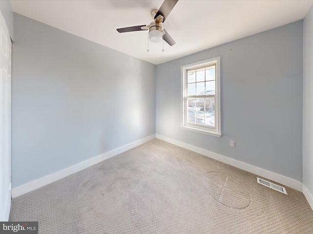 carpeted spare room with ceiling fan