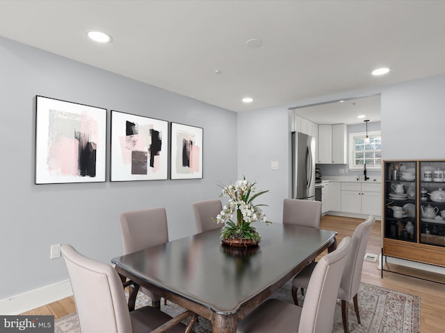 dining space featuring light wood-type flooring