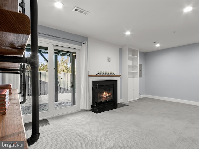 unfurnished living room featuring a wealth of natural light and carpet floors