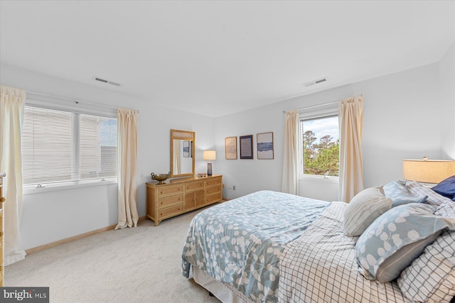 bedroom featuring light carpet