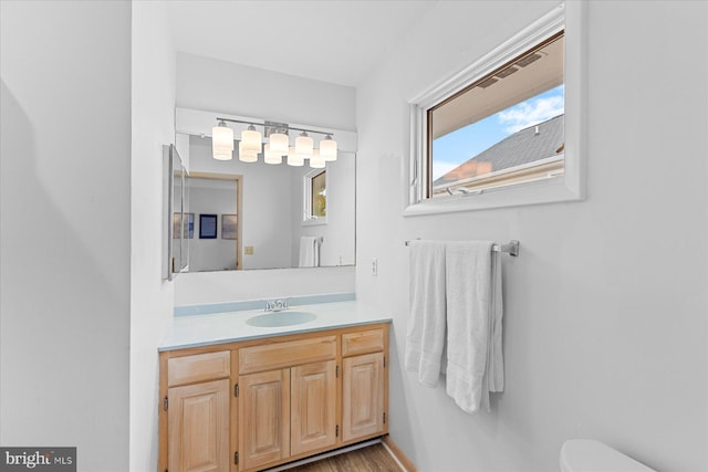 bathroom featuring vanity and toilet