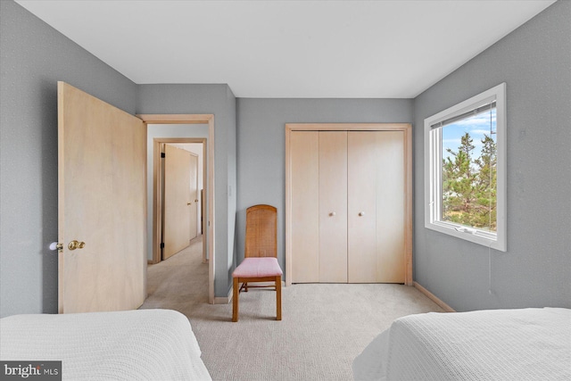 carpeted bedroom with a closet