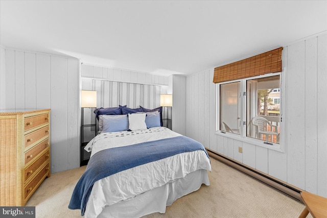 bedroom with wood walls, light colored carpet, and a baseboard radiator