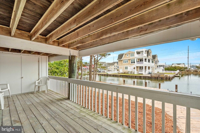 wooden terrace featuring a water view