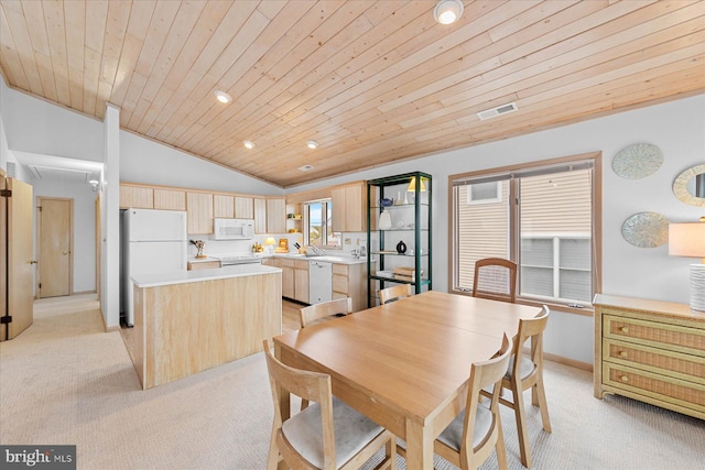 dining area with light carpet, vaulted ceiling, and wood ceiling