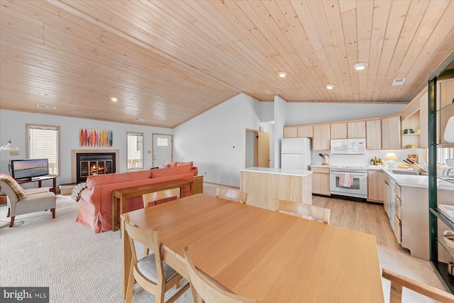 dining area featuring light hardwood / wood-style flooring, wood ceiling, and lofted ceiling