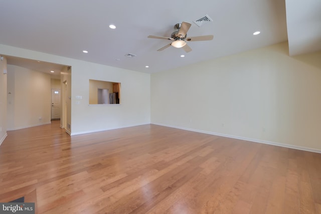 spare room with light hardwood / wood-style flooring and ceiling fan