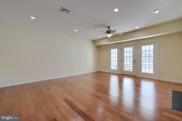 spare room featuring ceiling fan and light wood-type flooring