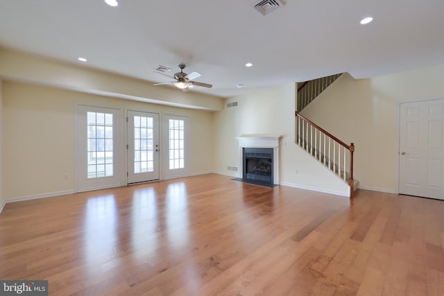 unfurnished living room with ceiling fan and light wood-type flooring