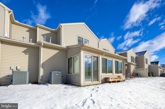 snow covered property with cooling unit