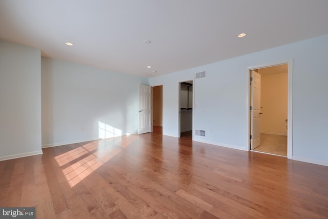 empty room with light hardwood / wood-style flooring