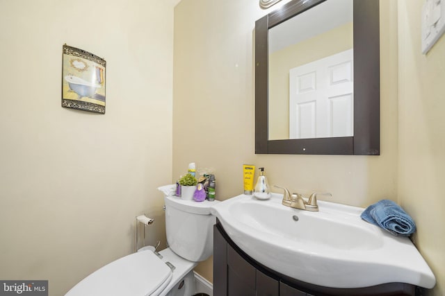 bathroom featuring toilet and vanity