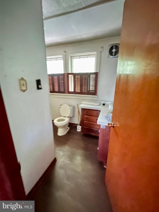 bathroom featuring vanity and toilet