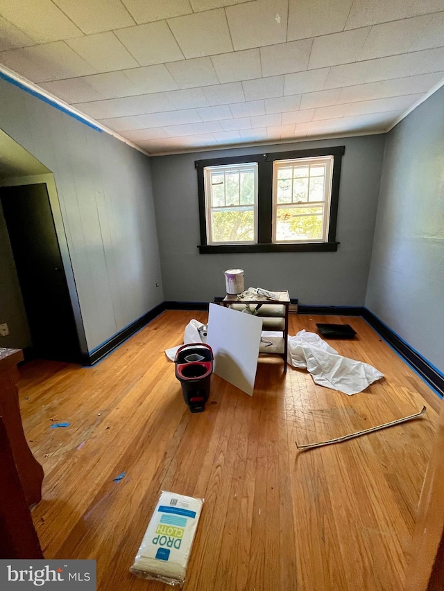 spare room featuring hardwood / wood-style floors and crown molding