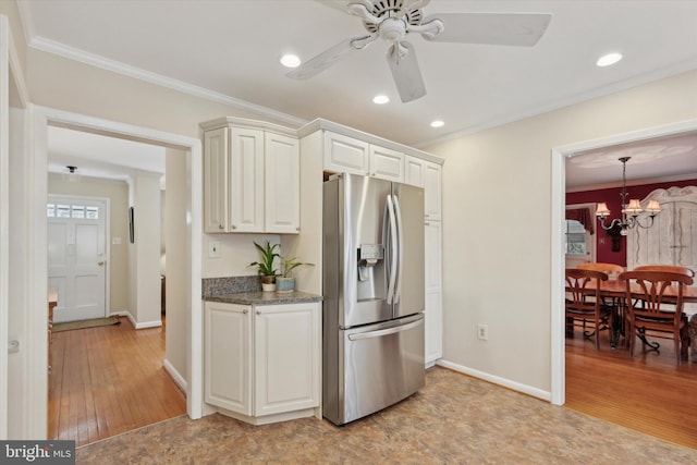 kitchen with ceiling fan with notable chandelier, ornamental molding, light hardwood / wood-style floors, and stainless steel fridge