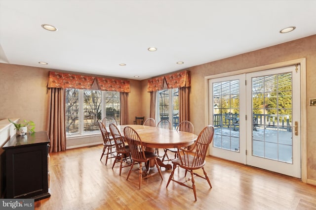 dining space with plenty of natural light and light hardwood / wood-style flooring